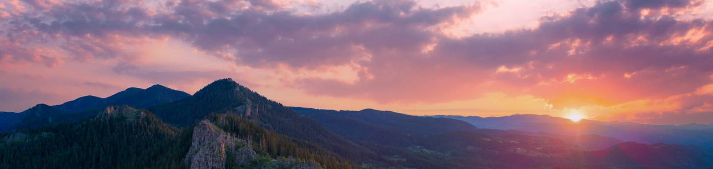 pink and purple sunset over mountain range